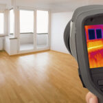 A thermal image scanner pointed at household windows to show heat leaking through.